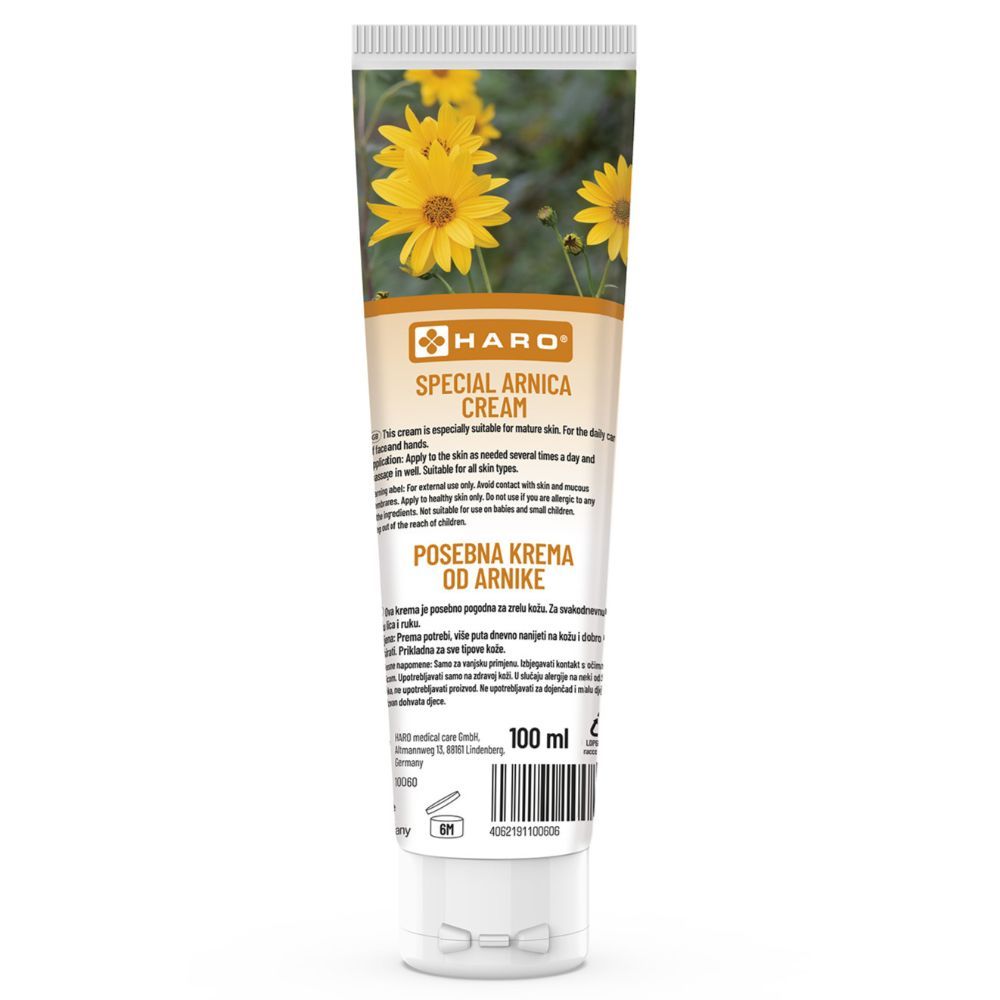 Crèmetube met gele bloemen en tekst. Tekst: Haro Special Arnica Cream. 100 ml. Witte dop.