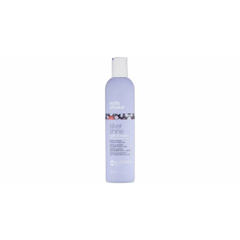 Flacon de shampooing lilas avec bouchon blanc. Inscription: milk_shake, Silver Shine light shampoo. 250 ml.