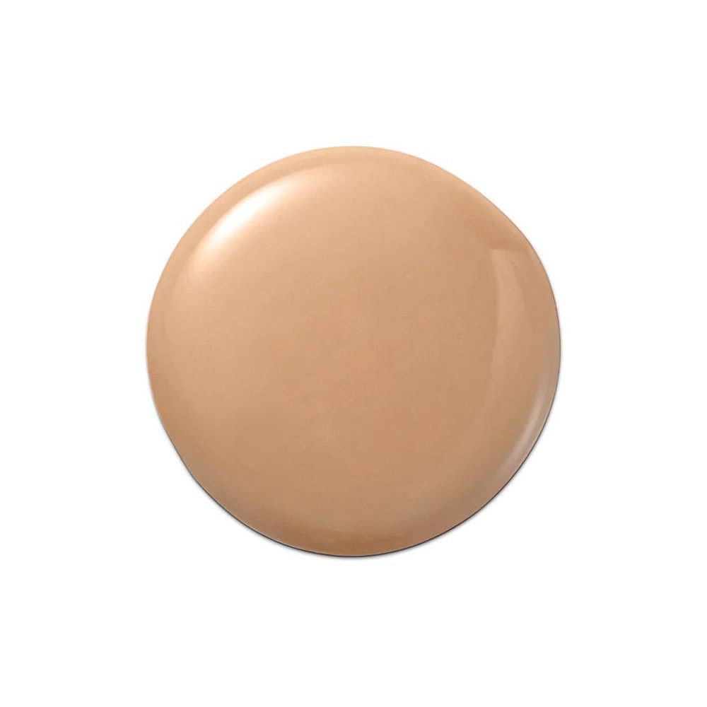 Goutte de fond de teint. Forme ronde, couleur beige. Surface brillante. Sur fond blanc.