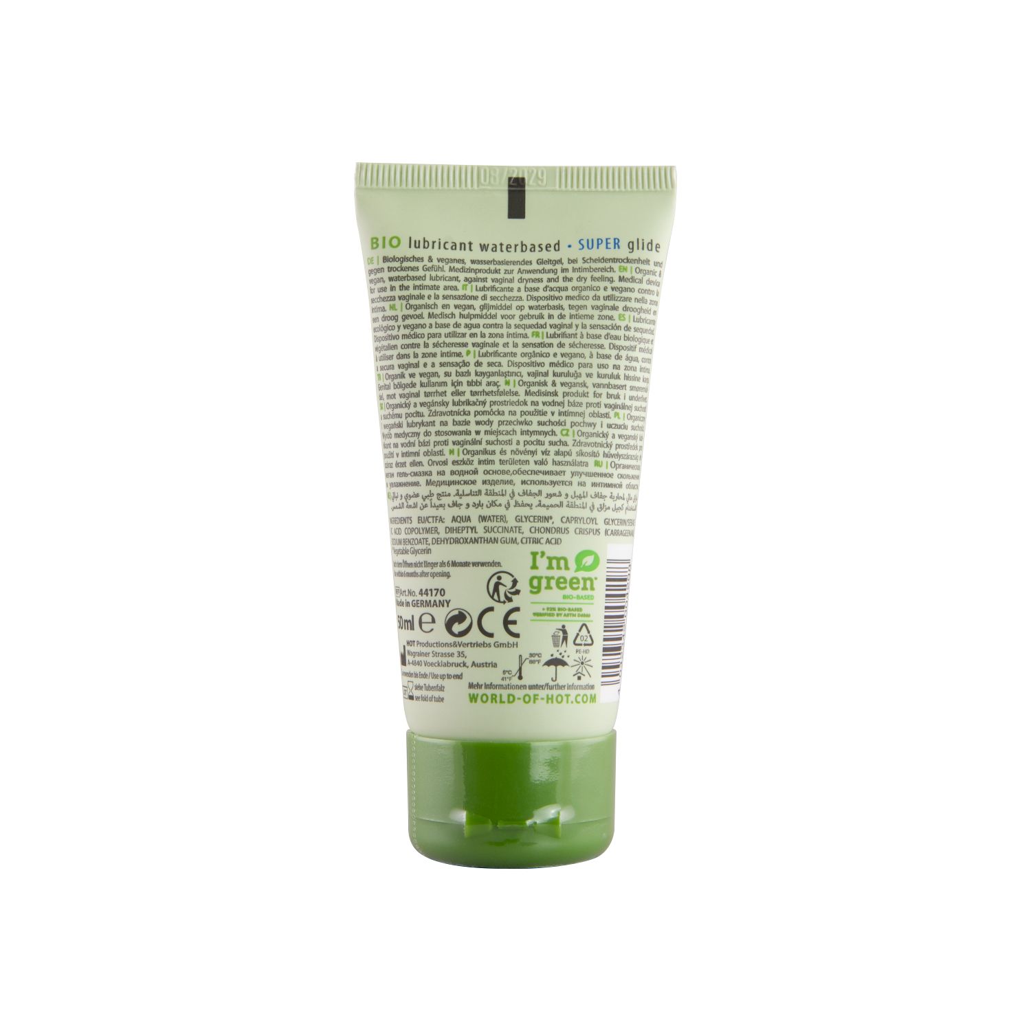 Achterkant van een groene tube. Meertalige tekst. Vegan label, 'I'm green' label. Website adres.