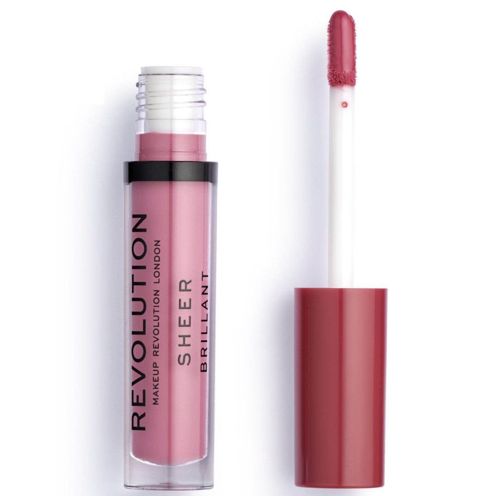 Tube de gloss avec applicateur. Tube transparent avec contenu rose. Bouchon noir, bouchon rouge. Inscription: REVOLUTION LONDON SHEER BRILLANT.