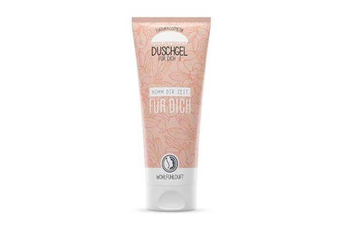 Tube de gel douche beige avec motif floral et texte. Inscription : Duschgel, Nimm Dir Zeit für Dich. Avec sceau.