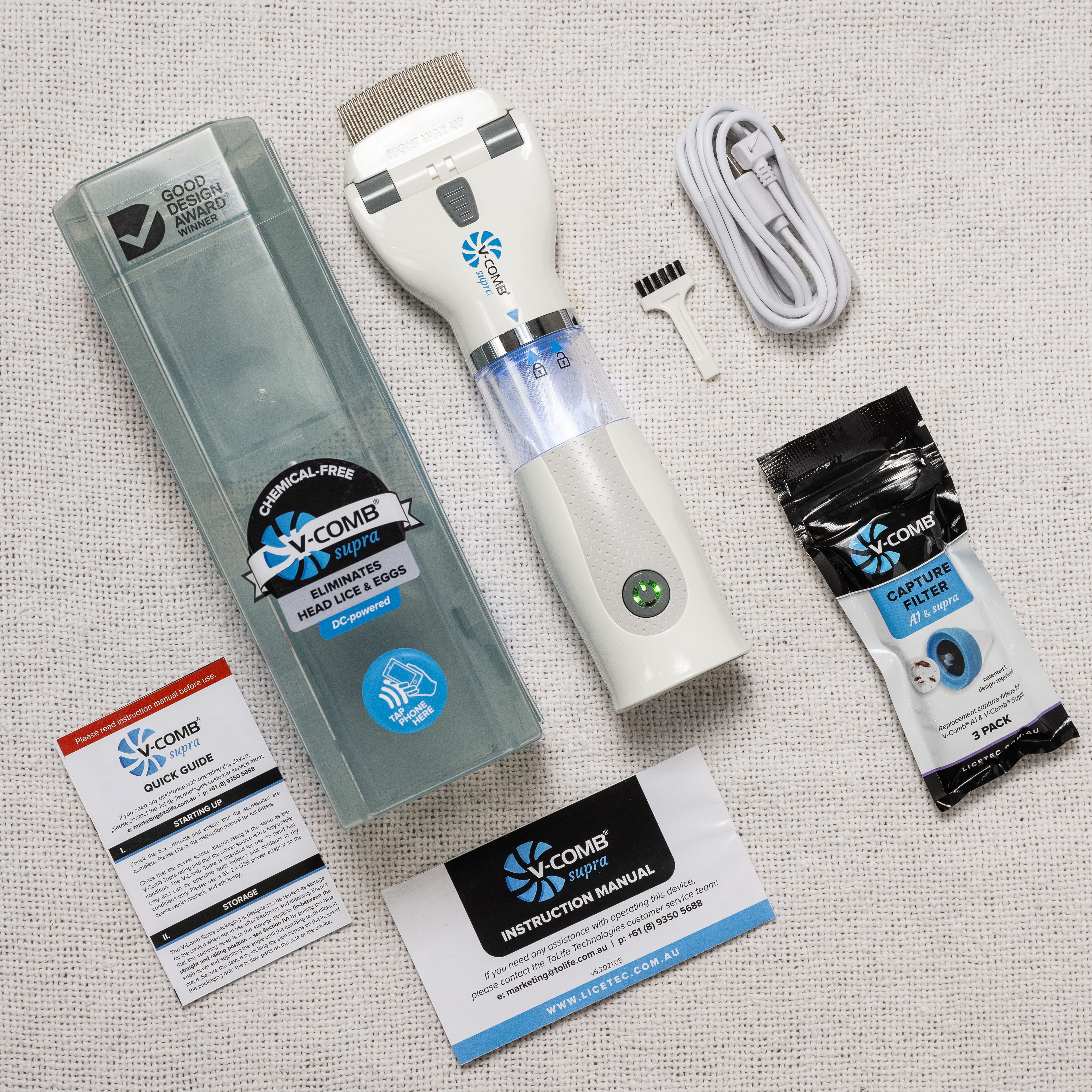 Ensemble de peigne anti-poux V-COMB Supra : appareil, câble, brosse, filtres, notices.