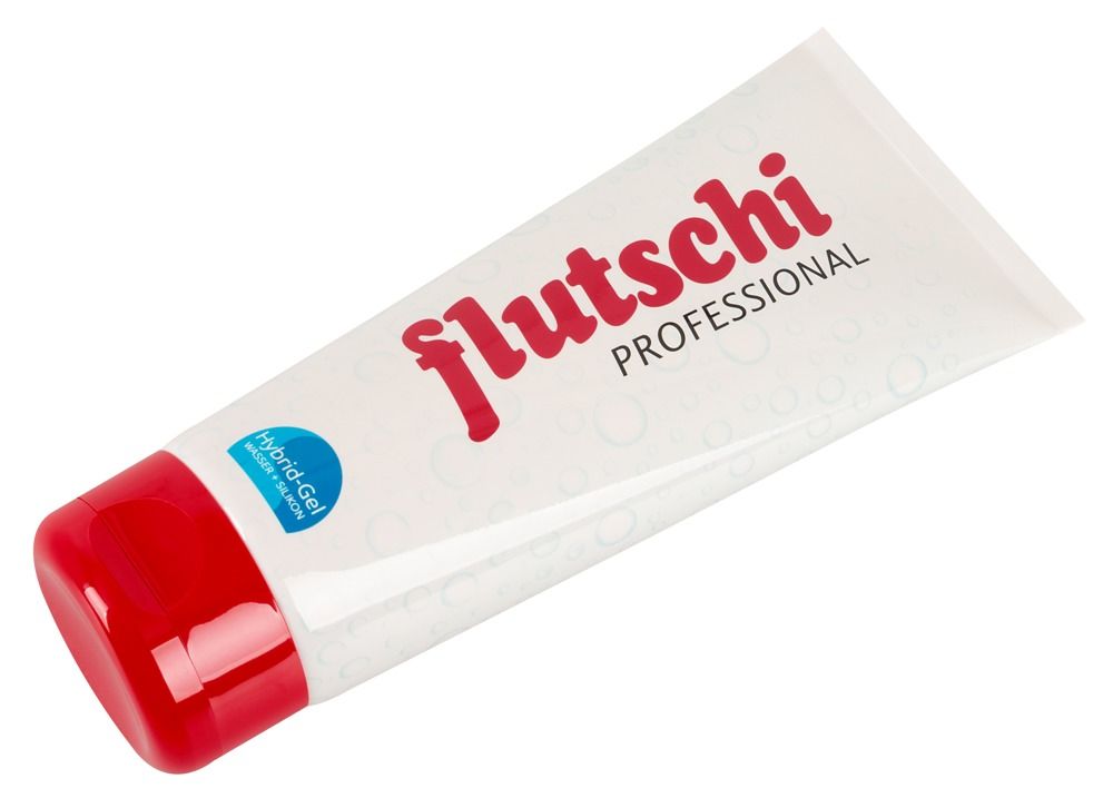 Tube tenu dans la main. Blanc avec bouchon rouge. Inscription : flutschi PROFESSIONAL. Hybrid-Gel.
