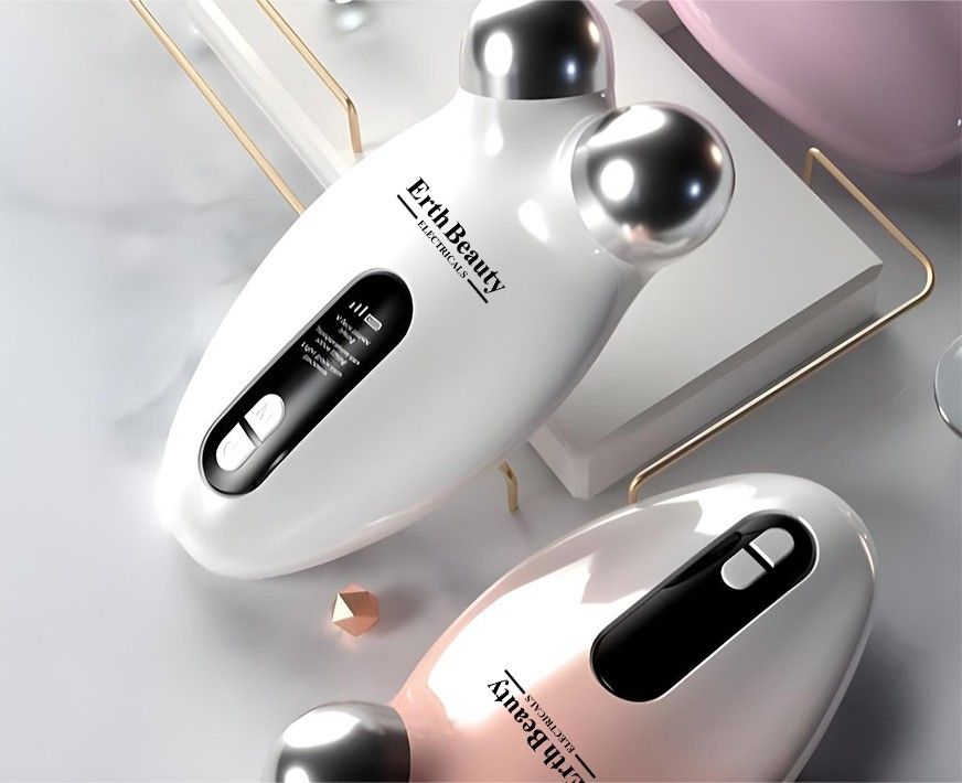 Deux appareils de lifting facial blancs avec sphères argentées. Inscription : "Erth Beauty Electrical".