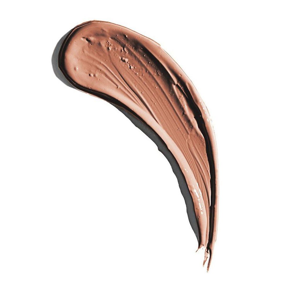 Un tourbillon de rouge à lèvres crémeux brun sur fond blanc. Le tourbillon a une forme incurvée.