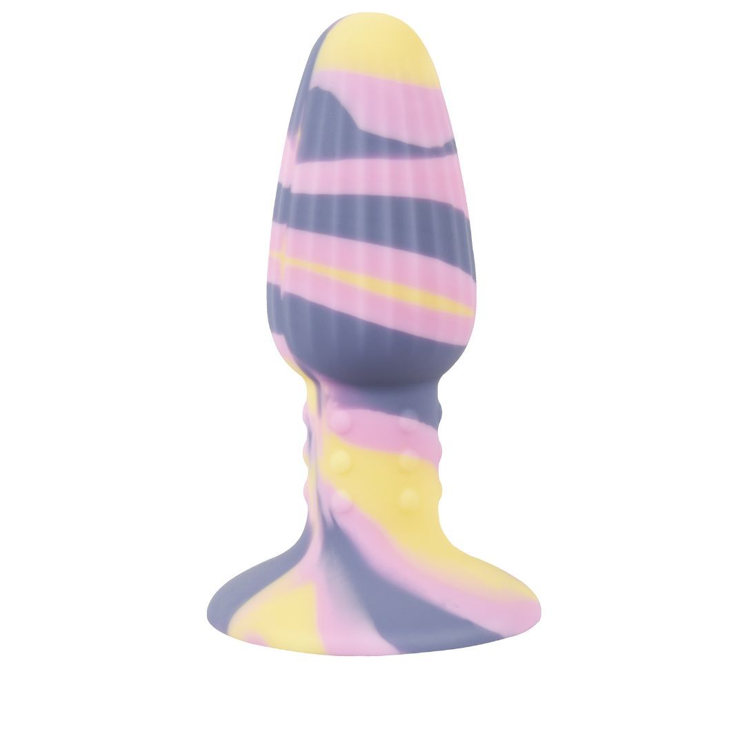 Plug anal avec ventouse. Design multicolore jaune, rose et violet. Surface cannelée. Base avec ventouse.