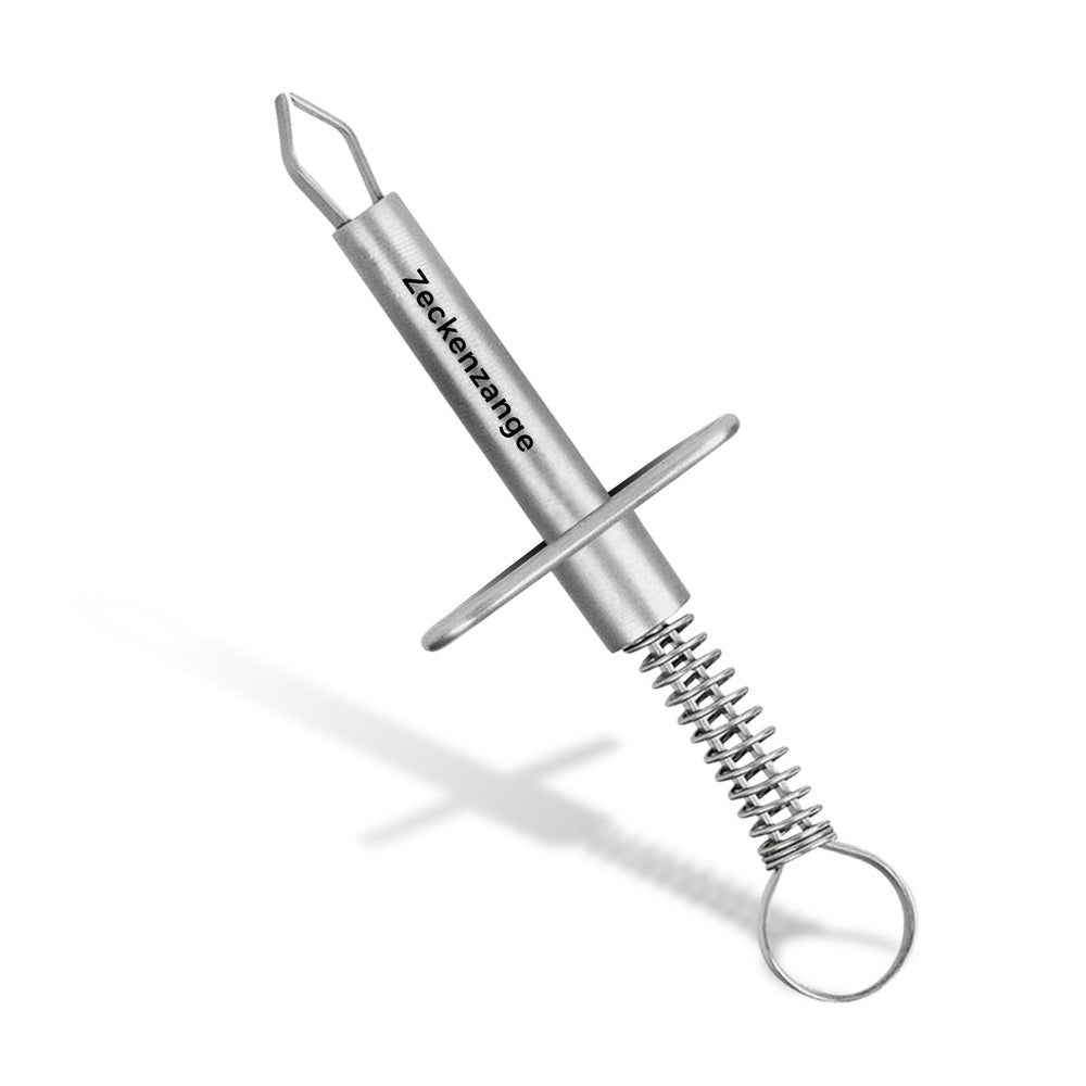 Pince à tiques en métal avec support et ressort. La poignée a un anneau. "Zeckenzange" est écrit sur la poignée.