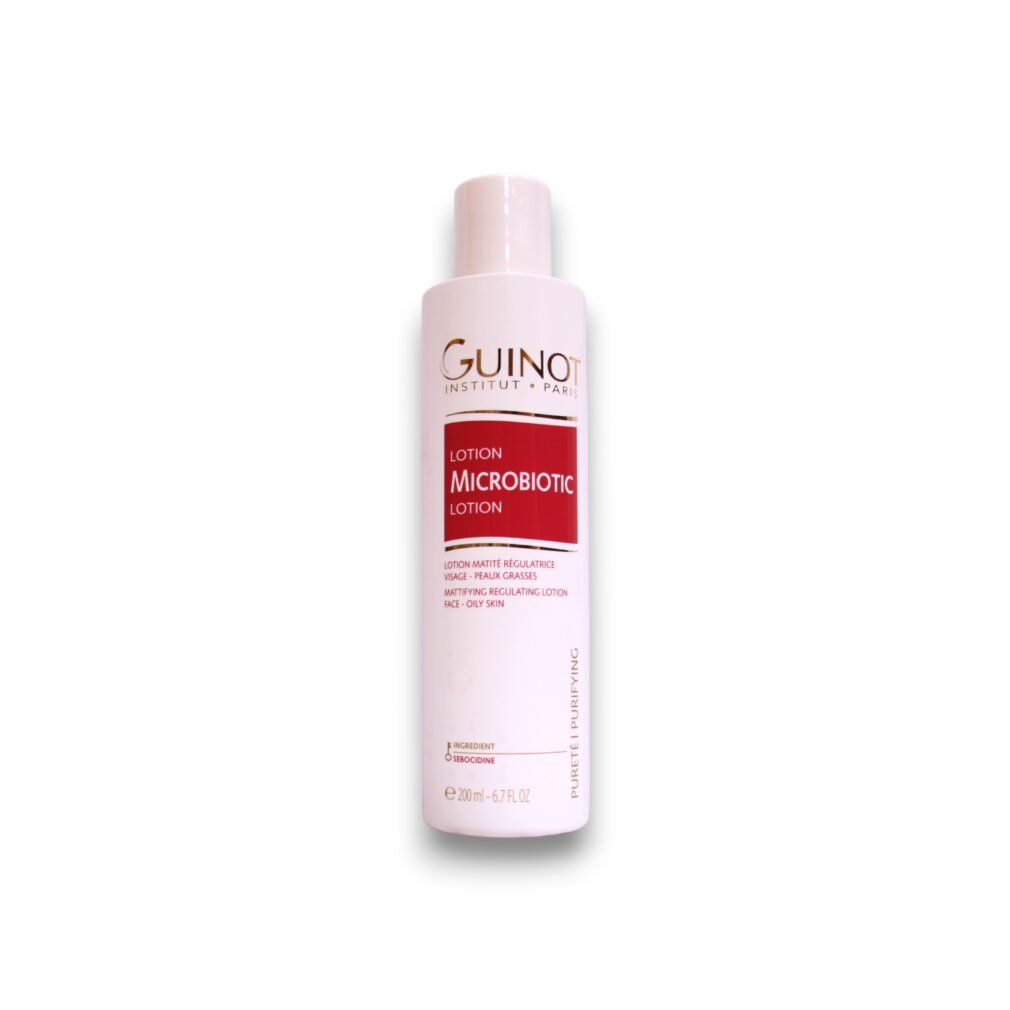 Witte fles Guinot Microbiotic. Rood etiket: Lotion Microbiotic, vette huid. 200ml. Witte dop.