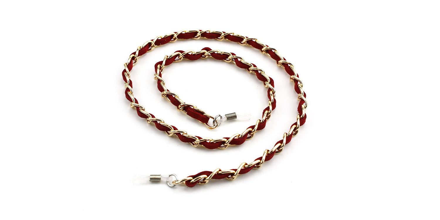 Cordon à lunettes avec tissu rouge et maillons dorés. Extrémités avec boucles transparentes.
