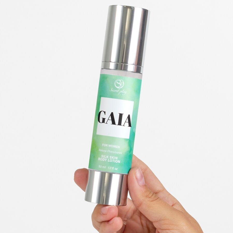 Zilverkleurige bodylotionfles met groen etiket. Tekst: GAIA, Silk Skin Body Lotion. Hand houdt de fles vast.