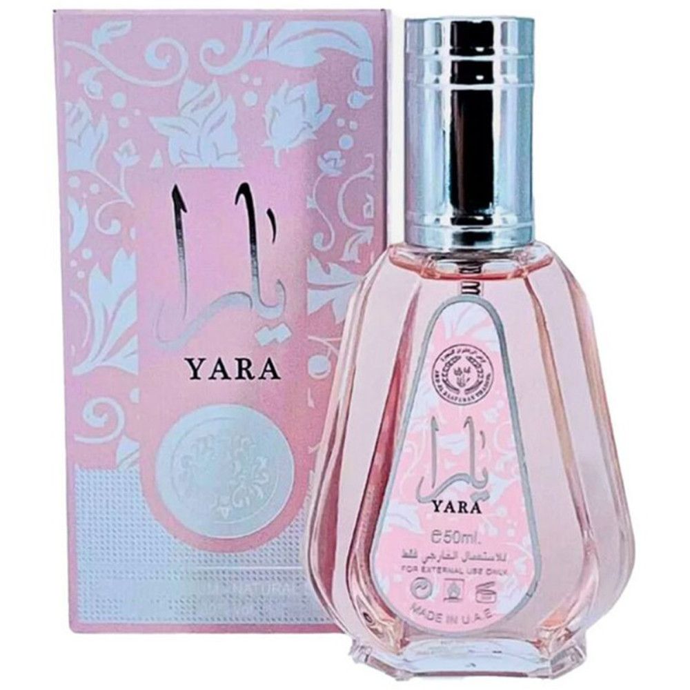 Flacon rose avec bouchon argenté et emballage. Inscription "YARA". Caractères arabes. Motifs floraux sur l'emballage.