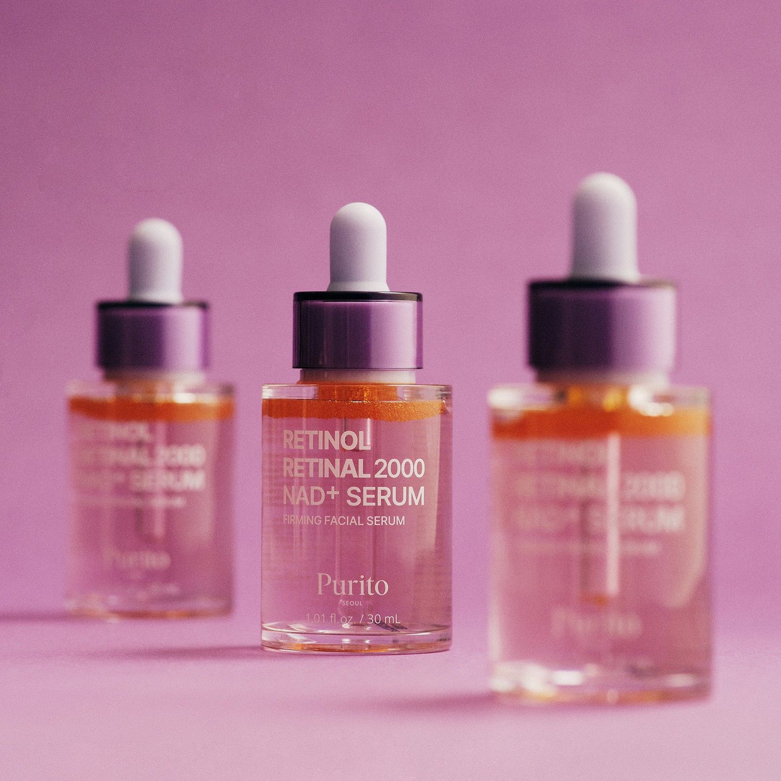 Trois sérums Purito Retinol Retinal 2000 NAD+ dans des flacons en verre avec pipettes.