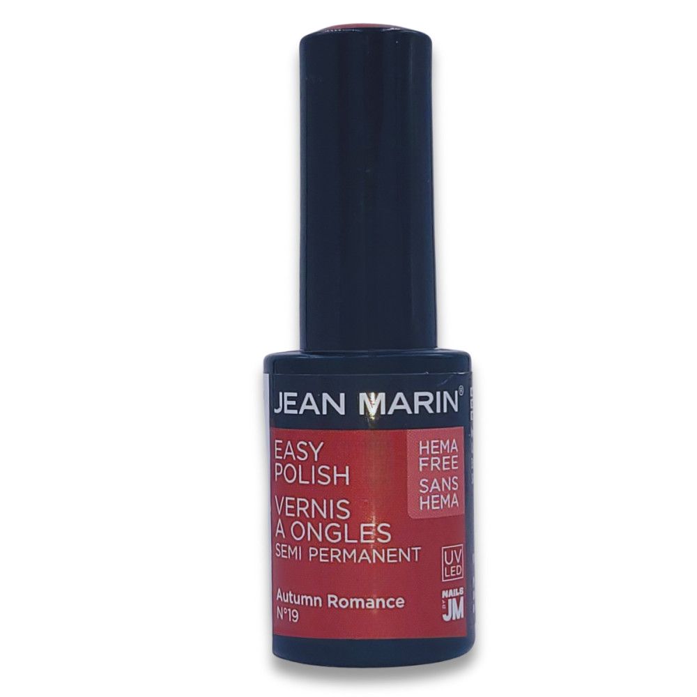 Flacon de vernis à ongles Jean Marin. Bouchon noir, étiquette rouge avec informations produit. "HEMA FREE" et "Autumn Romance" visibles.