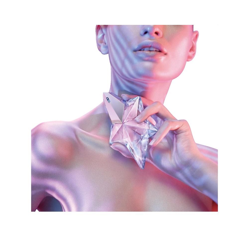 Een vrouw houdt een stervormige fles bij haar nek. De fles is transparant met een zilveren dop. Gekleurde achtergrond.