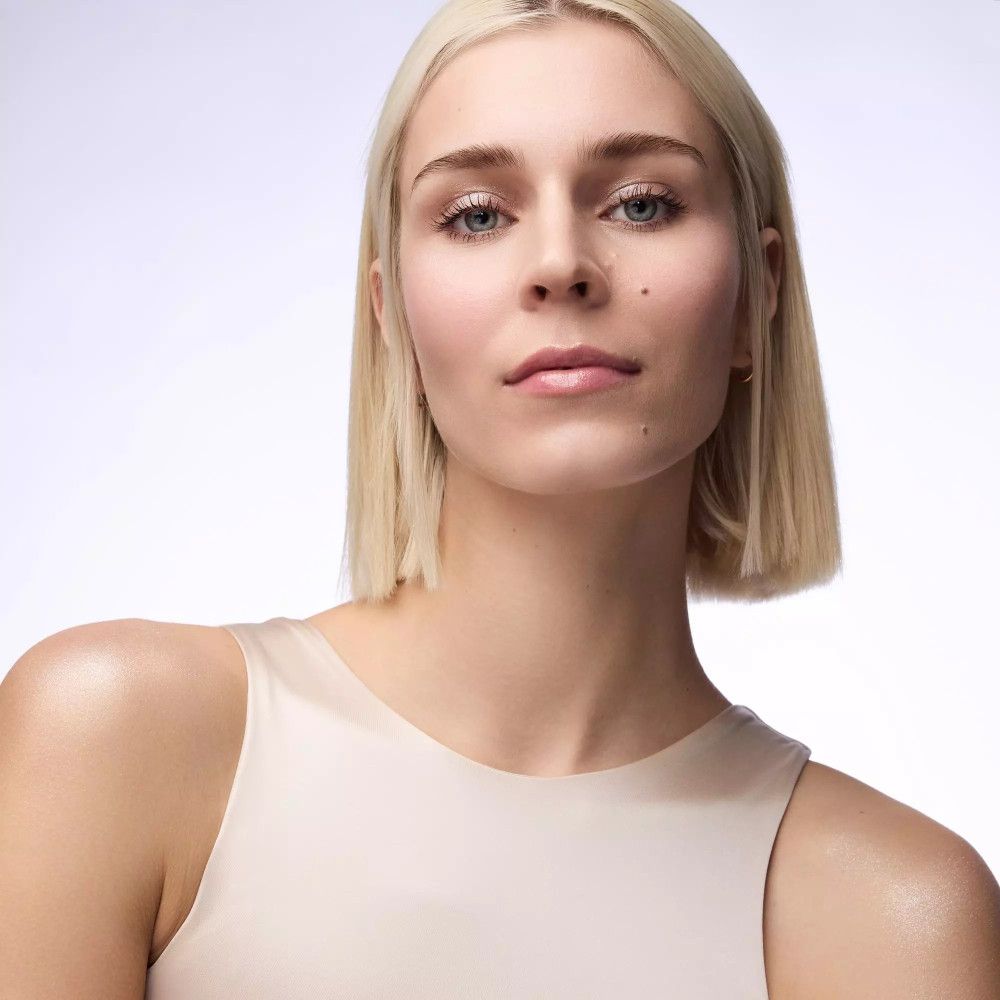 Portrait d'une femme aux cheveux blonds et haut clair. Regard droit devant.