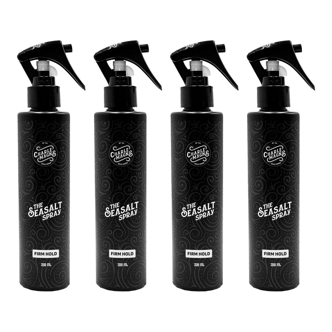 Vier zwarte spuitflessen met opschrift "The Seasalt Spray" en "Firm Hold".