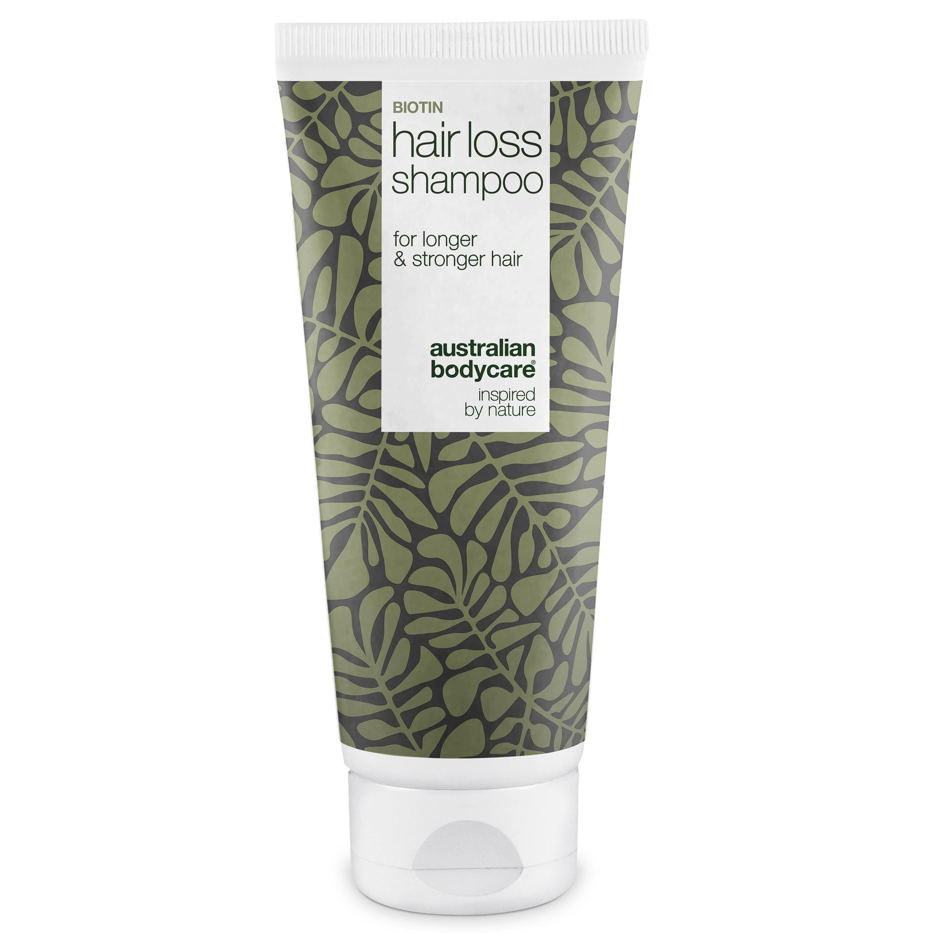 Shampoo anti-chute Biotine. Tube à motif de feuilles vertes. Texte: for longer & stronger hair. Australian Bodycare.