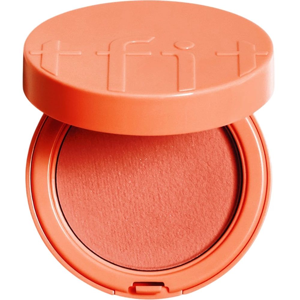 Een ronde, perzikroze TFIT Fluffy Velvet Cushion Blush met open deksel. De blush is zichtbaar.