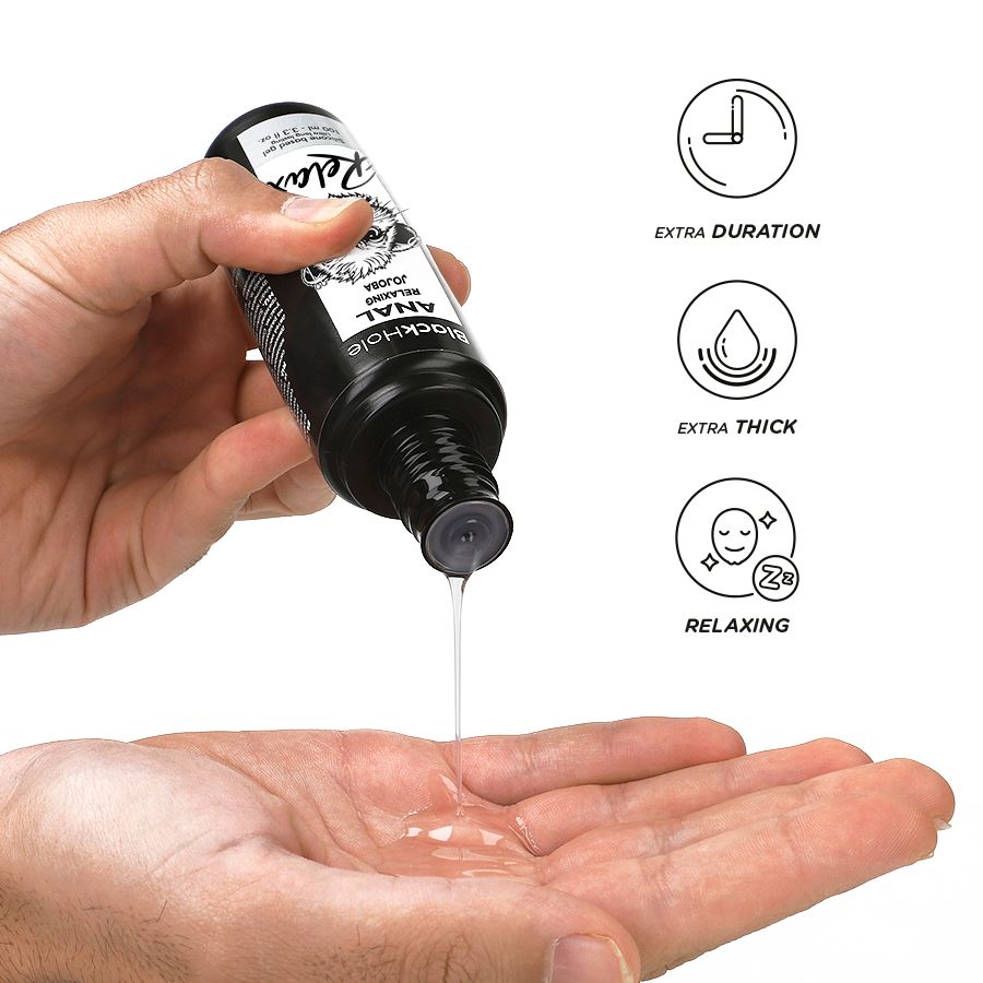 Une main tient un flacon, un liquide coule dans l'autre main. Symboles: Durée extra, Extra épais, Relaxant.