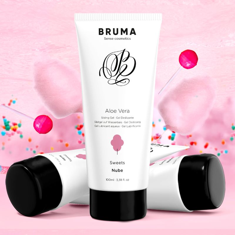 Tube blanc, bouchon noir. Inscription: Bruma, Aloe Vera, barbe à papa. Deux autres tubes en arrière-plan.