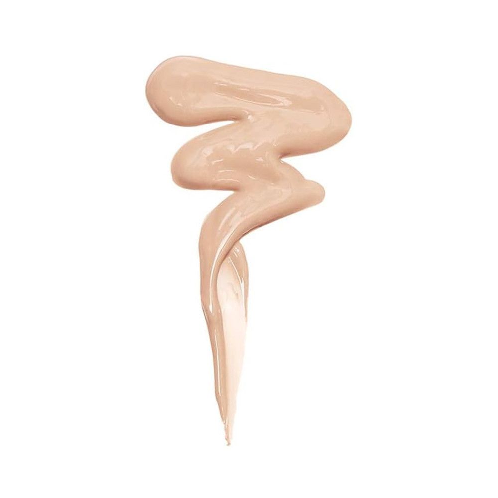 Éclaboussure de correcteur beige en forme de vague sur fond blanc.