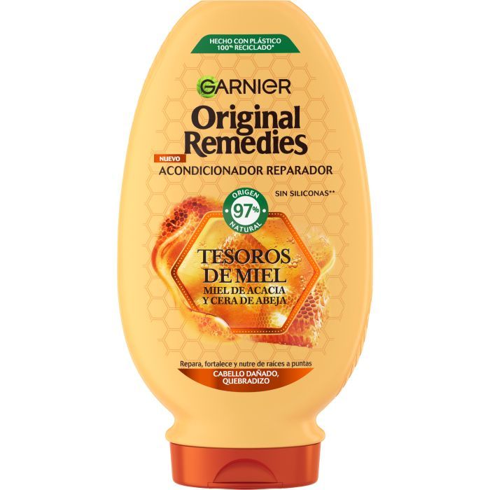 Flacon jaune de revitalisant Garnier Original Remedies. Inscription: Tesoros de Miel, Miel de Acacia y Cera de Abeja. 97% d'origine naturelle.