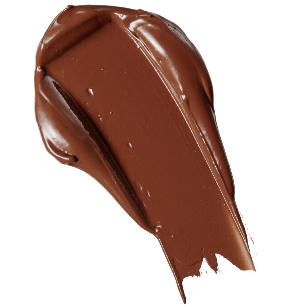 Échantillon de correcteur brun sur fond blanc. Texture visible.