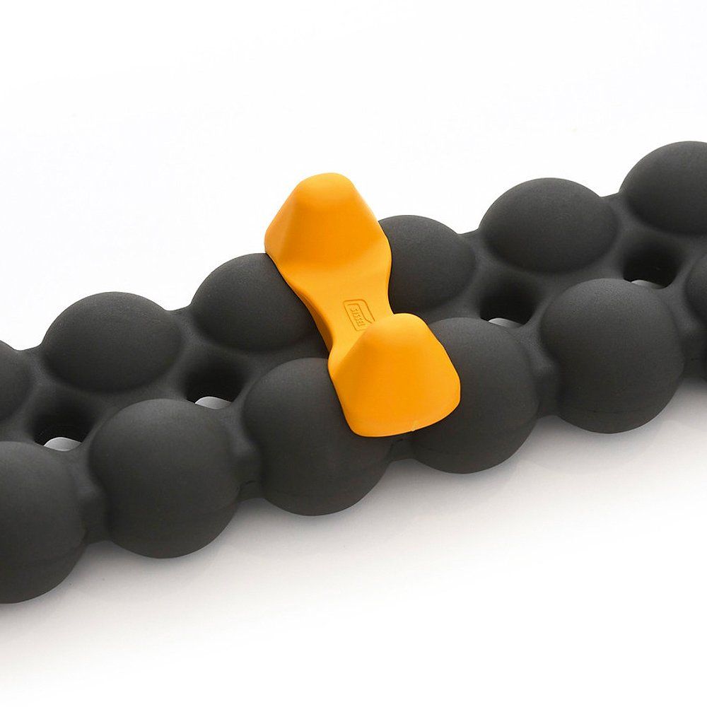 Spinefitter noir avec outil de déclenchement jaune. L'outil est inséré dans les boules du Spinefitter.