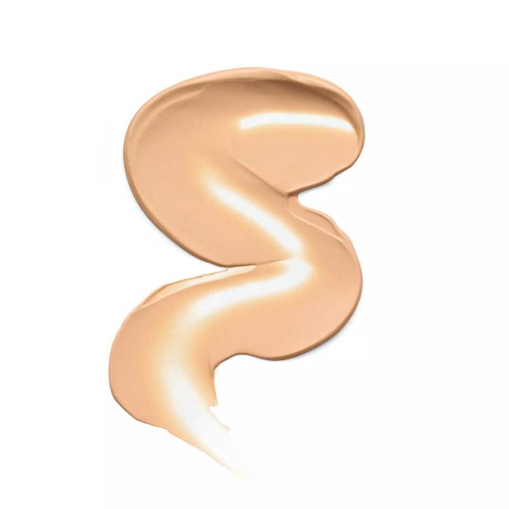 Lichte, crèmekleurige primer-veeg op witte achtergrond. De textuur is glad en licht gebogen.