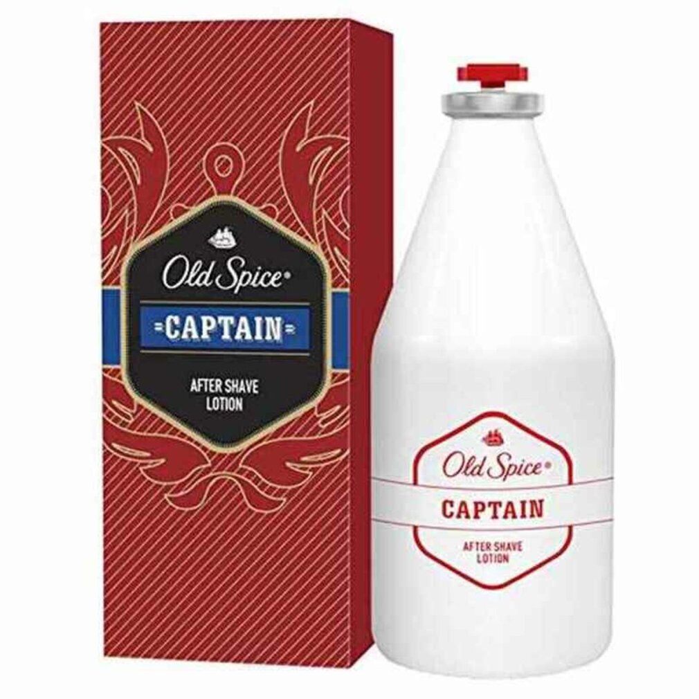 Flacon blanc et emballage rouge. Inscription: Old Spice Captain After Shave. Accents rouges et bleus.