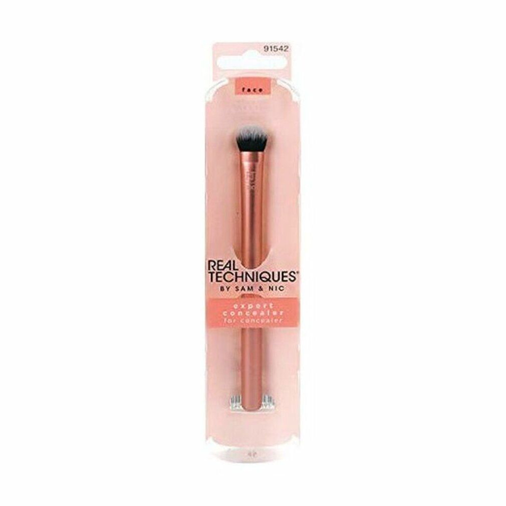 Emballage avec un pinceau. "REAL TECHNIQUES" et "EXPERT CONCEALER" sont écrits sur l'emballage.
