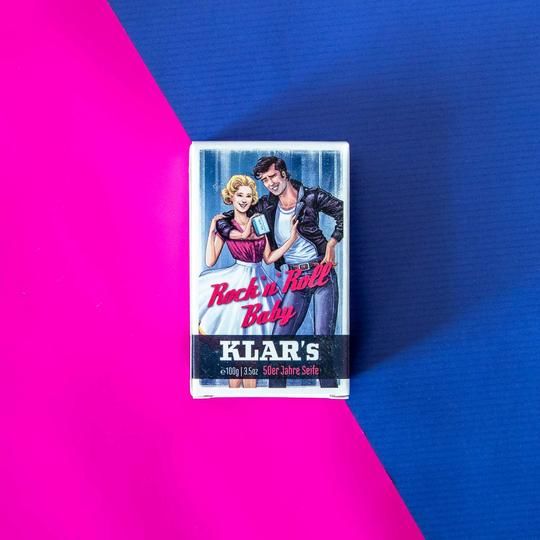 Zeep in retroverpakking. Opdruk: Rock 'n' Roll Baby, Klar's, 50er Jahre Seife. Achtergrond: roze en blauw.