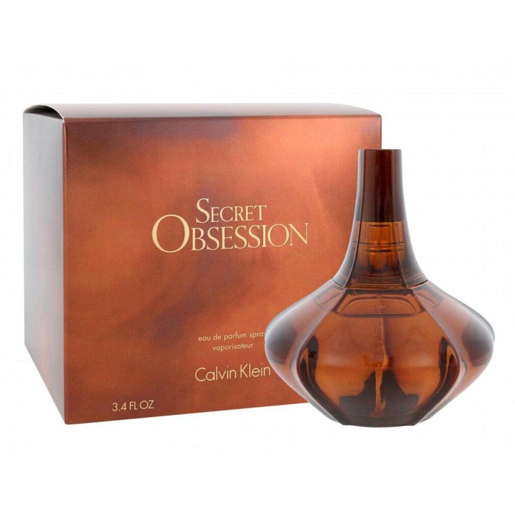 Bruine fles met ronde buik en smalle hals. Daarnaast verpakking met "Secret Obsession" en "Calvin Klein".