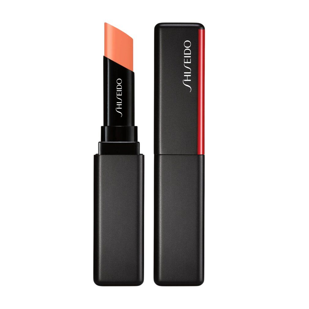 Stick à lèvres Shiseido, étui noir avec accent rouge. Le stick de couleur pêche est visible. Marque Shiseido.