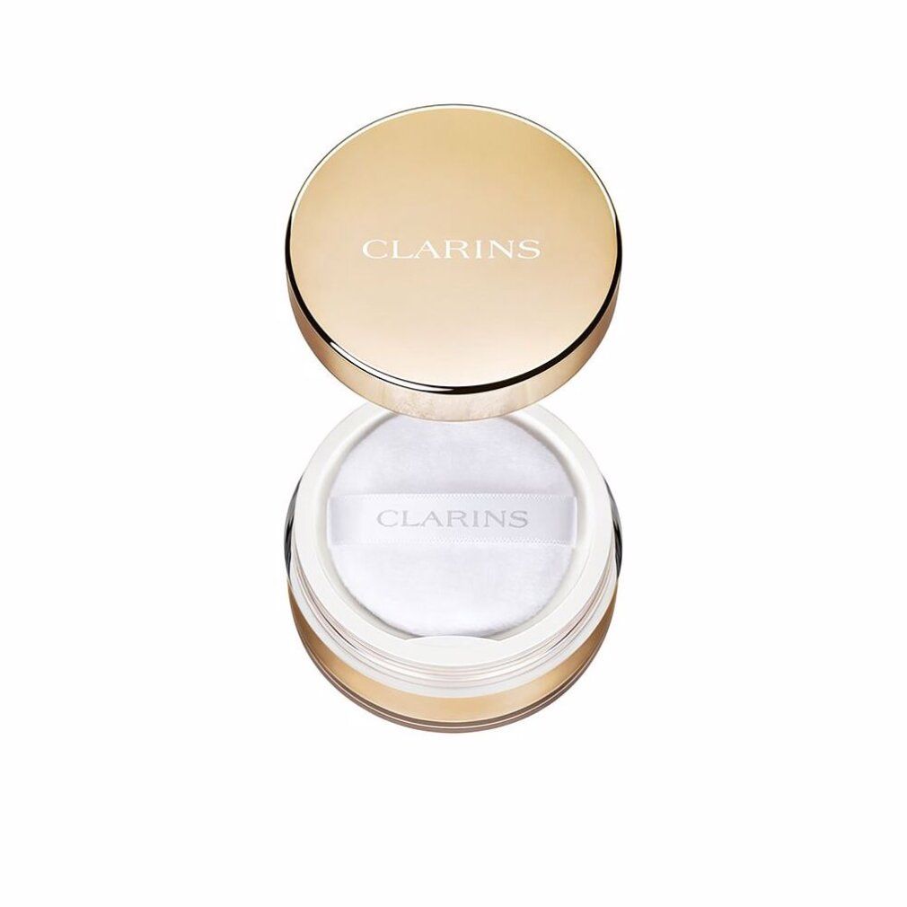 Poudre Clarins dans un pot doré avec un houppette blanche.