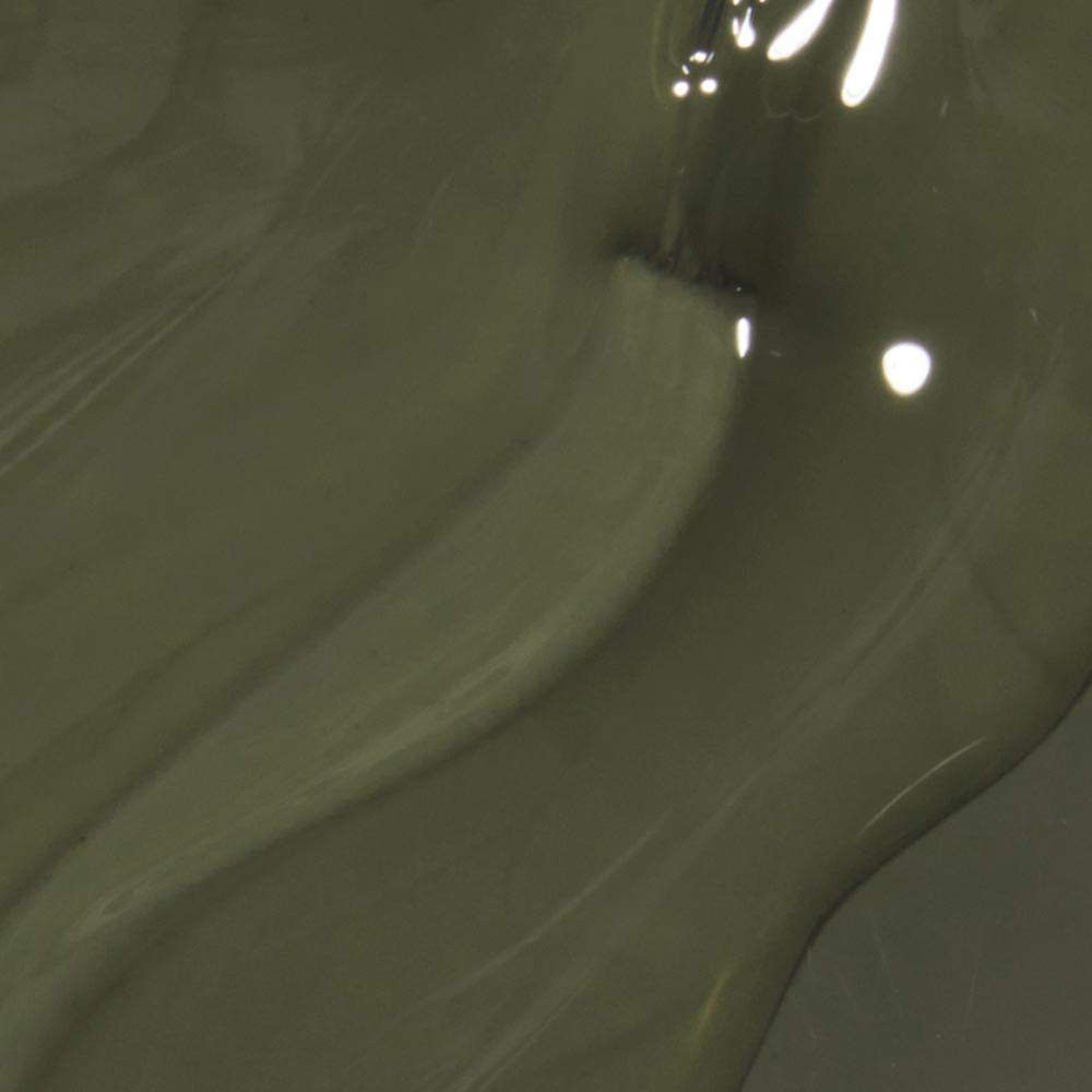 Pinceau de vernis à ongles dans un liquide vert olive. Vue rapprochée. Surface brillante.