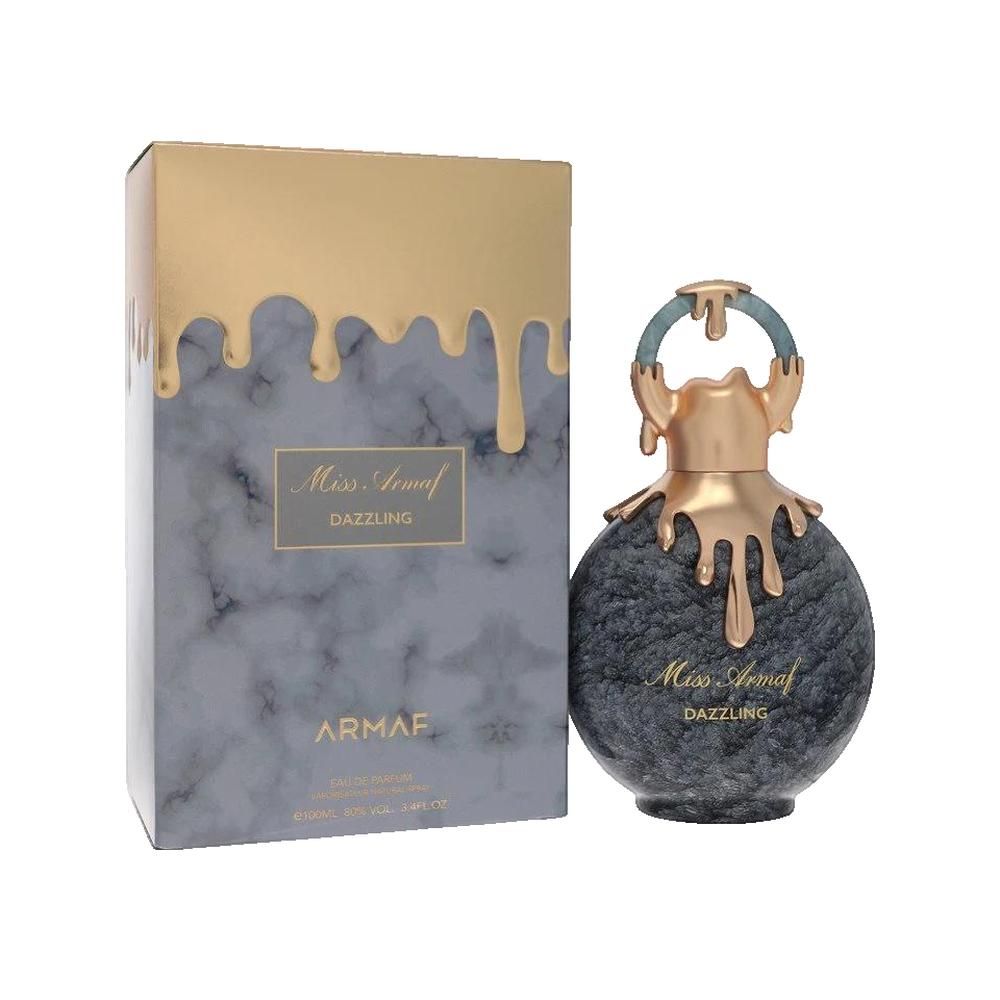 Parfumfles en doos. Ronde fles, grijs gemarmerd, gouden elementen. Gemarmerde doos, gouden opzetstuk. Opschrift: Miss Armaf Dazzling.