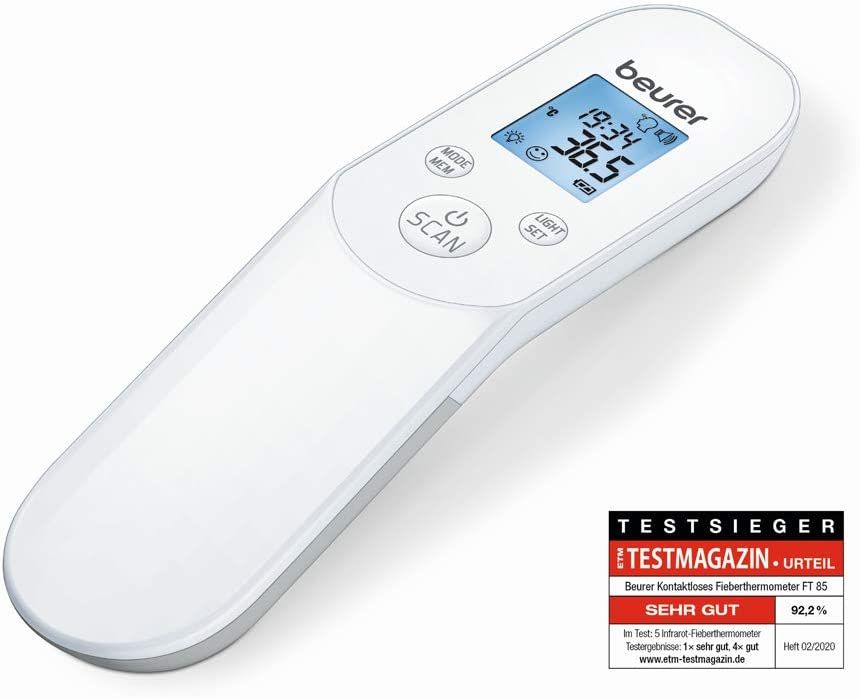 Witte thermometer met blauw display. Toont temperatuur, tijd en symbolen. Tekst: Testmagazin-Urteil, Zeer Goed. Merk: Beurer.