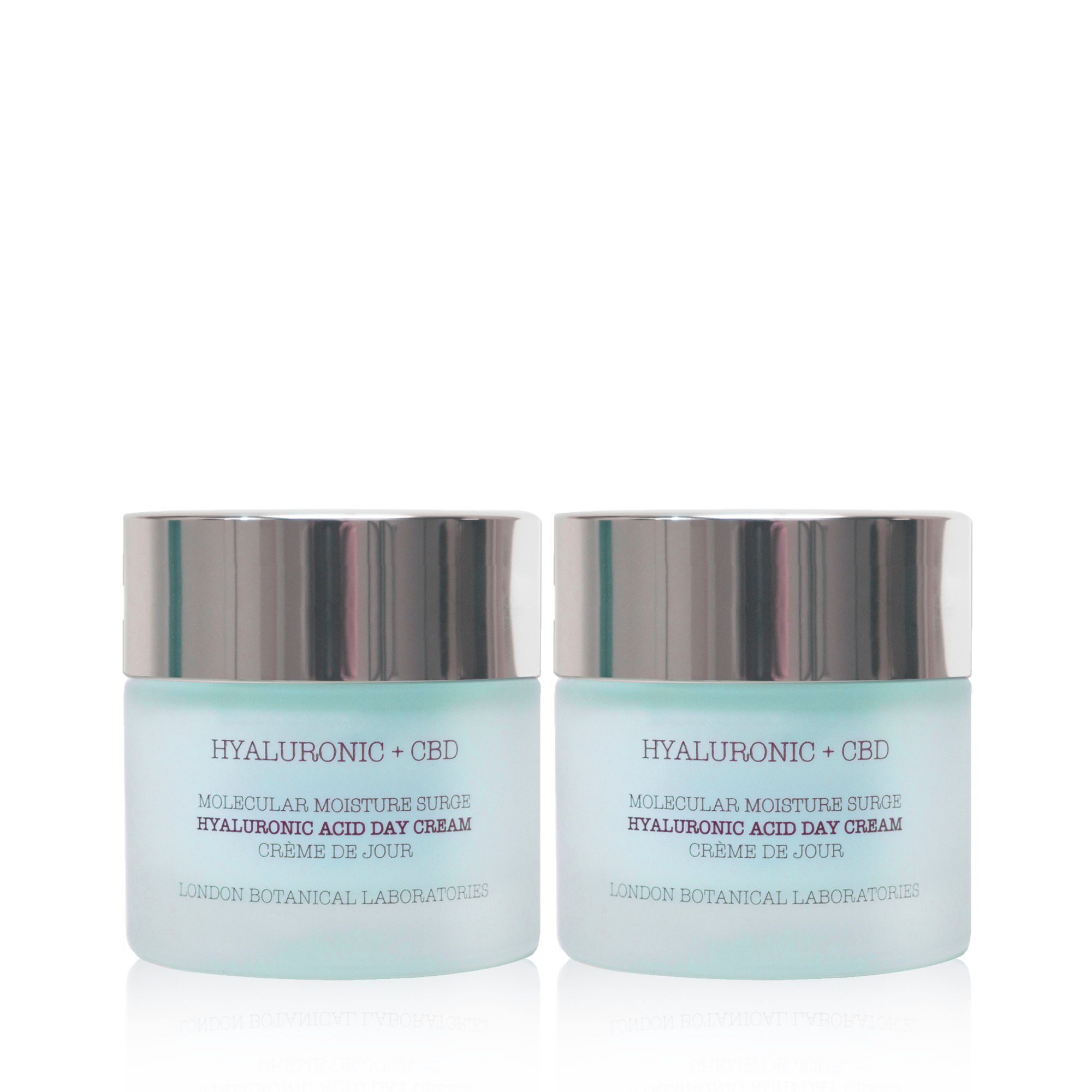 Twee potjes dagcrème met zilveren deksels. Opschrift: Hyaluronic + CBD, Molecular Moisture Surge, Crème de Jour. London Botanical Laboratories.