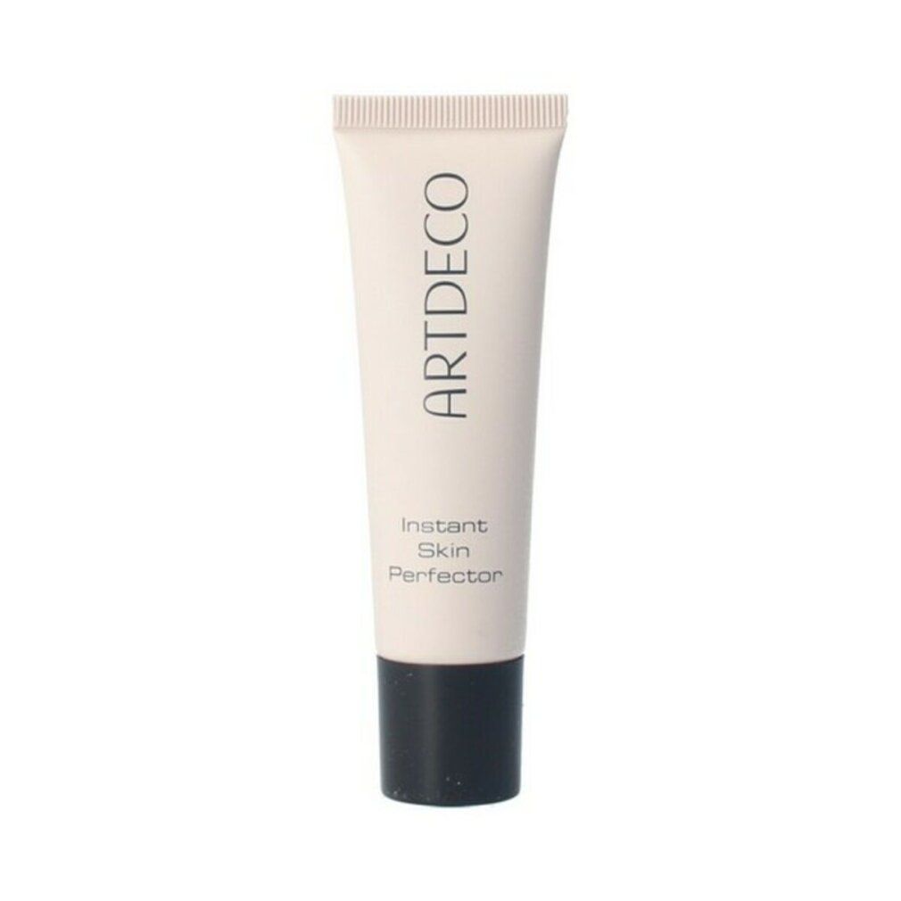 Tube de produit. Inscription ARTDECO, Instant Skin Perfector. Tube rose, bouchon noir. Fond blanc.