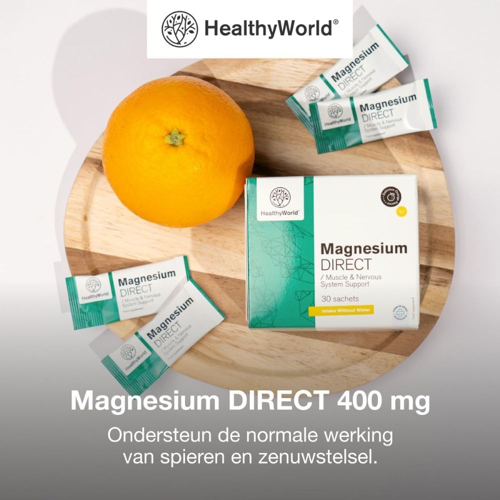 Magnesium DIRECT 400 mg, 30 zakjes. Op houten plank met sinaasappels. Merk HealthyWorld.