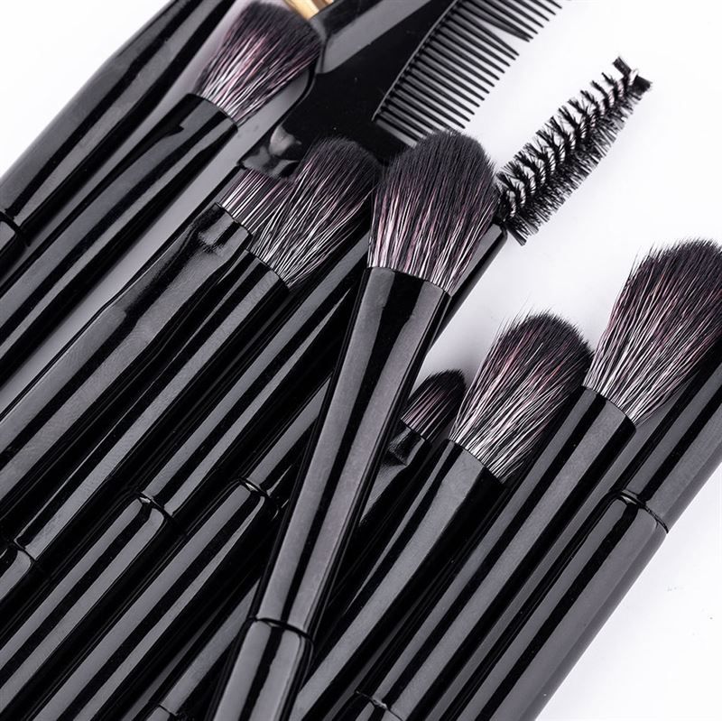 Gros plan sur des pinceaux noirs pour fard à paupières et sourcils, avec différentes têtes et un peigne.