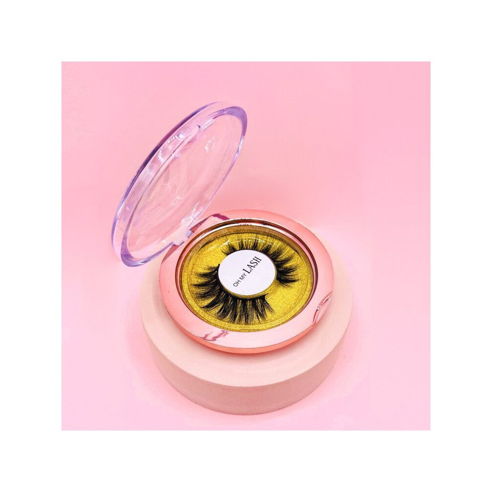 Faux cils dans un étui rose avec couvercle transparent. Inscription: OH MY LASH. Fond doré.