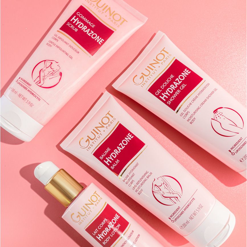 Vier tubes en een fles op roze achtergrond. De tubes tonen "HYDRAZONE" en "GUINOT".