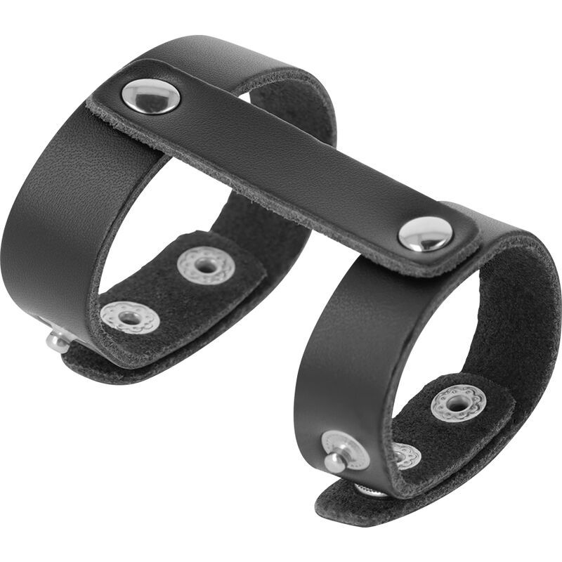 Harnais de pénis en cuir noir avec deux anneaux, reliés par une sangle et fixés par des rivets.