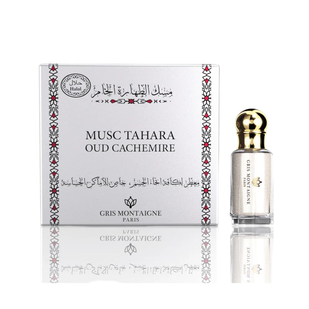 Produit avec emballage. Flacon à côté d'une boîte blanche avec inscription: Musc Tahara Oud Cachemire.