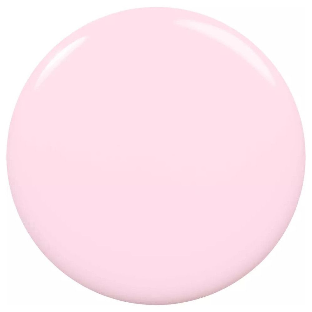 Druppel lichtroze nagellak. Ronde vorm, glanzend oppervlak.