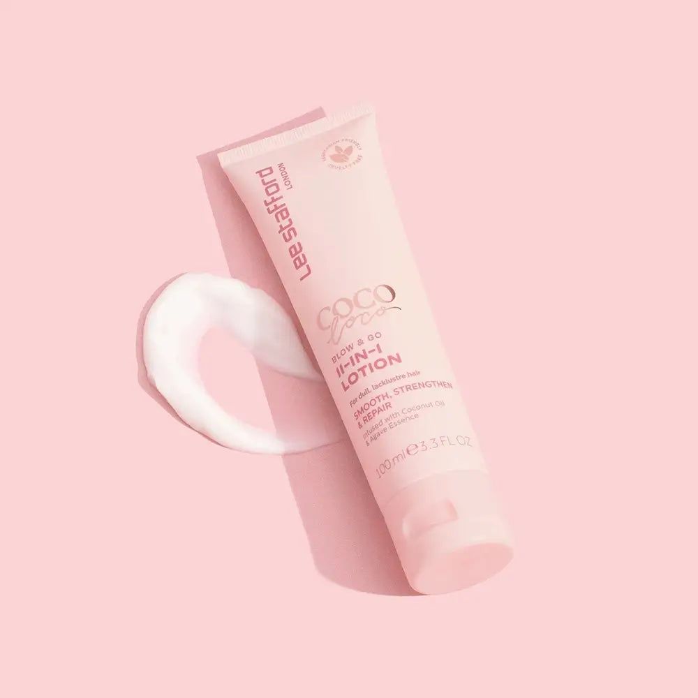 Tube rose Lee Stafford Coco Loco Blow & Go 11-en-1 Lotion avec une trace de lotion à côté.