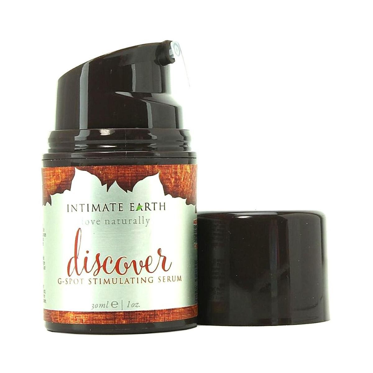 Flacon avec pompe noire et bouchon enlevé. Étiquette avec "Intimate Earth", "discover" et "G-Spot Stimulating Serum".